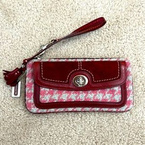 Coach wristlet, pink, grey, maroon in color. Barley used